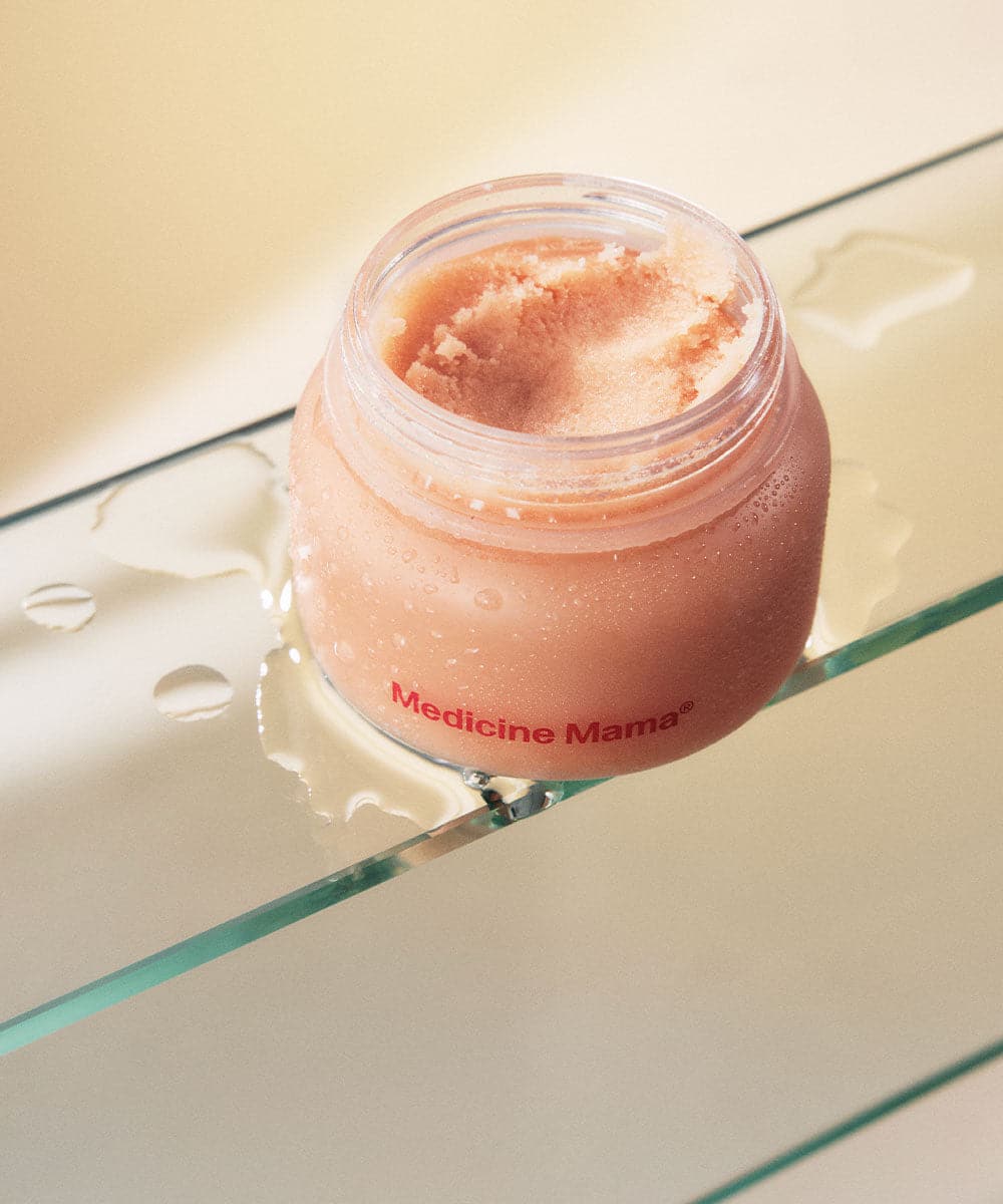 A small jar of VMAGIC® Grooming Polish by Medicine Mama sitting on top of a glass shelf.