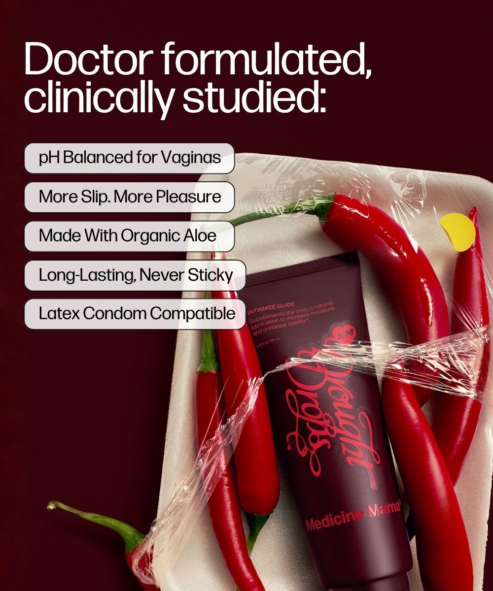 A tube labeled Drought Drops sits on a tray with red chili peppers and plastic wrap, featuring text that highlights it is a pH balanced, organic vaginal moisturizer with enhanced slip, long-lasting hydration, and is compatible with latex condoms.