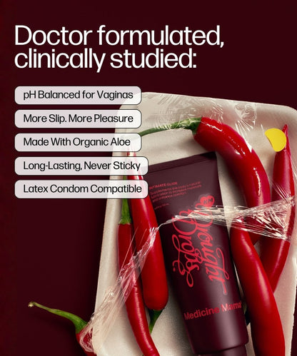 A tube labeled Drought Drops sits on a tray with red chili peppers and plastic wrap, featuring text that highlights it is a pH balanced, organic vaginal moisturizer with enhanced slip, long-lasting hydration, and is compatible with latex condoms.