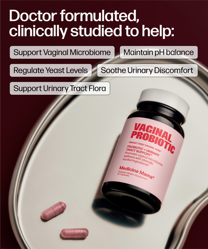 A bottle of Medicine Mama Vaginal Probiotic capsules displayed on a silver tray with two pink capsules. The background is a deep burgundy with white text detailing the probiotic's benefits for vaginal microbiome support, pH balance, yeast regulation, and urinary tract comfort.