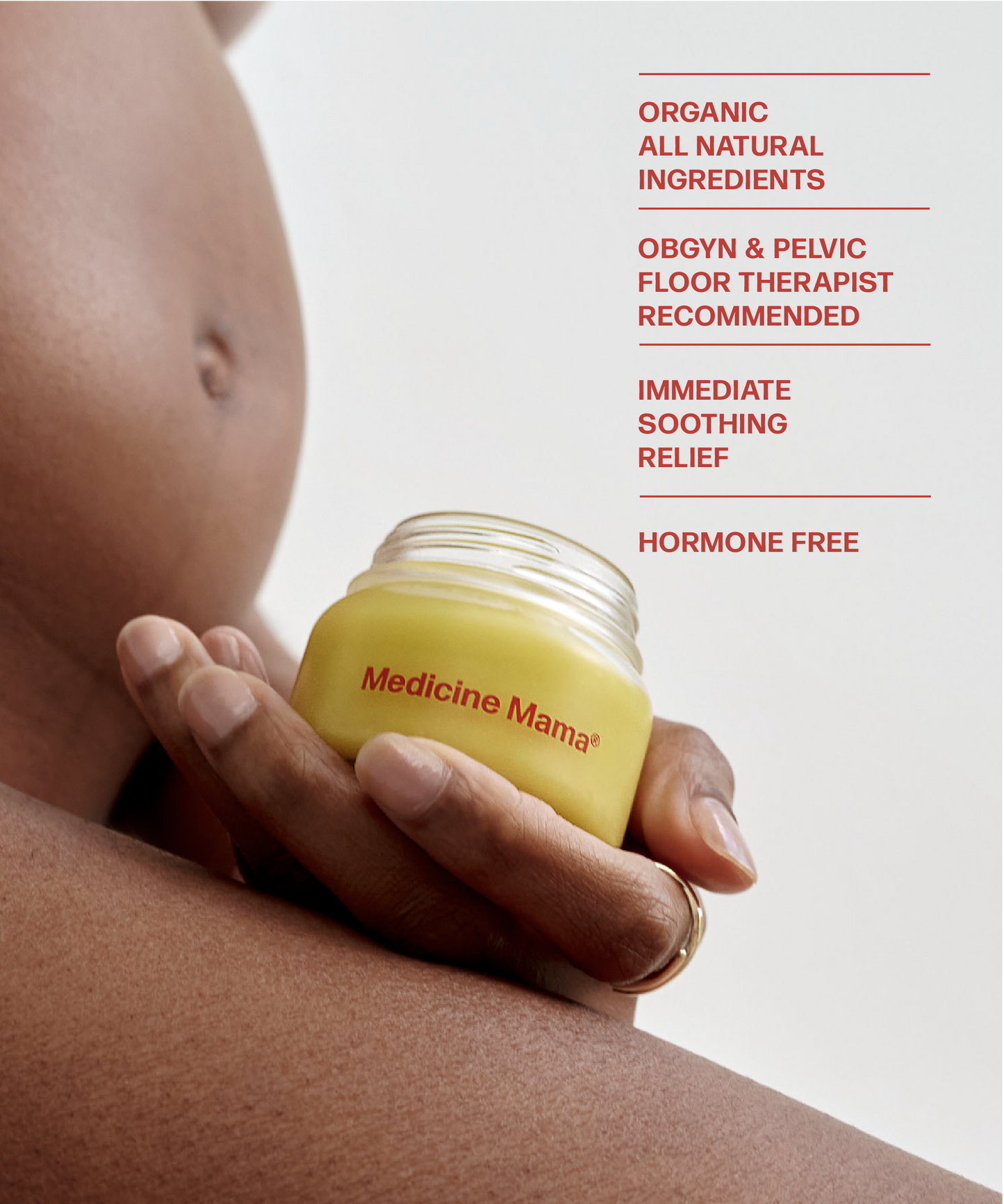 A pregnant woman holding an organic jar of Medicine Mama's VMAGIC® Vulva Balm moisturizer.