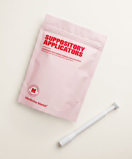 A pink package labeled "Vaginal Suppository Applicators" with the Medicine Mama logo sits beside a white applicator on a beige surface, offering a mess-free way to use vaginal suppositories.